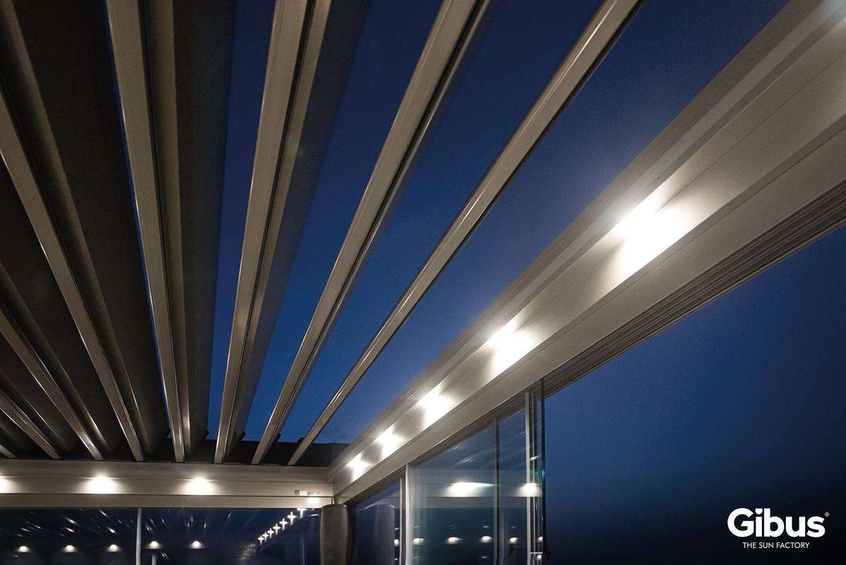 LED-Spots in den Lamellen einer Pergola am Abend